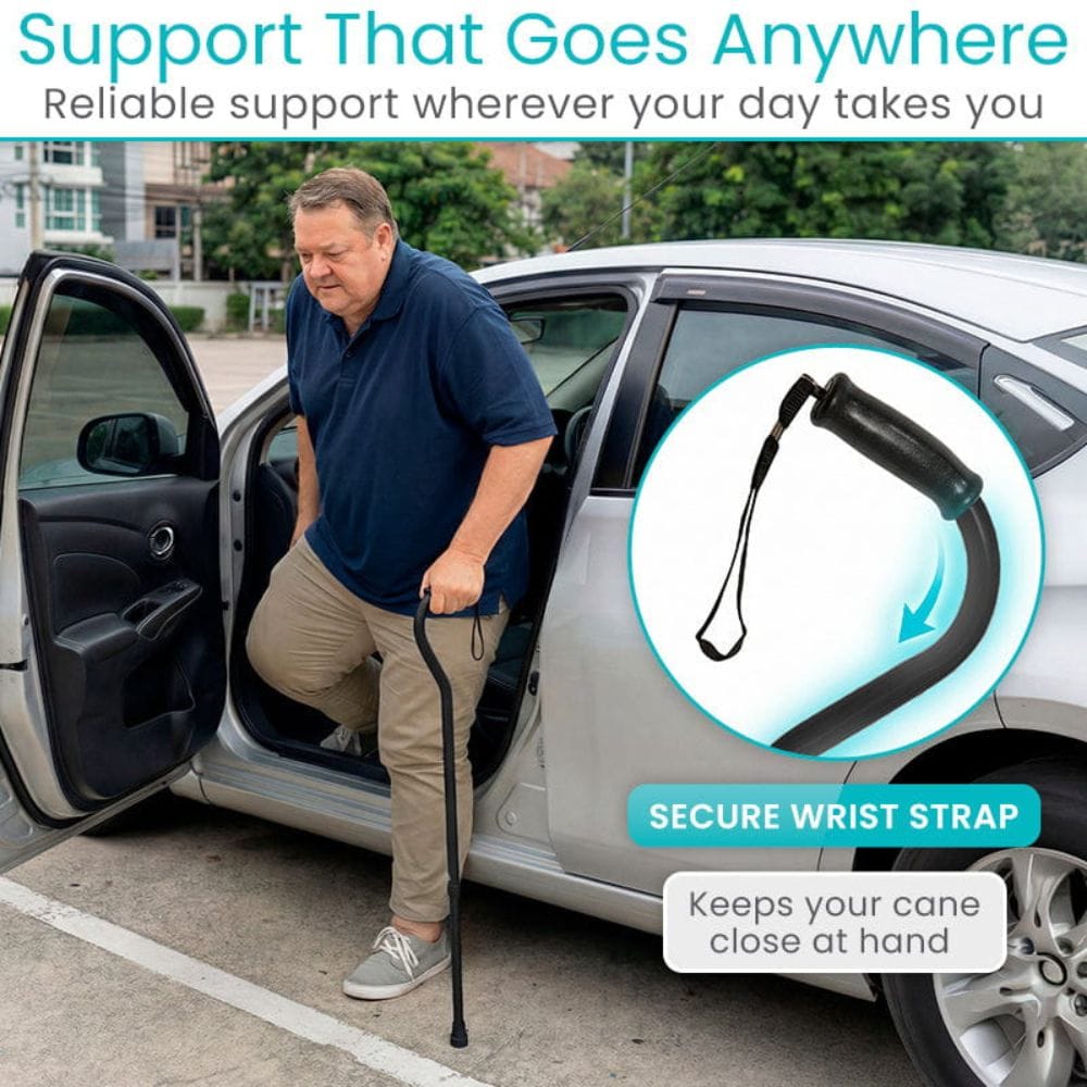 Man using a cane with a secure wrist strap attached, standing next to a car.