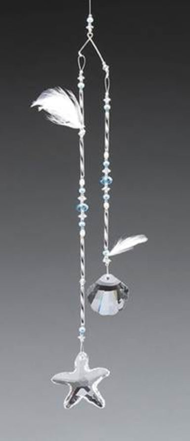 Decorative hanging ornament with feathers, beads, and a crystal on a gray background