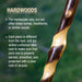 Wooden stick with text about hardwoods on a blurred green background