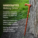 Handcrafted walking cane leaning against a tree with promotional text about its traditional craftsmanship.