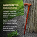 Handcrafted walking cane leaning against a tree with promotional text about its traditional craftsmanship.