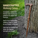 Handcrafted walking cane leaning against a tree with promotional text about its traditional craftsmanship.