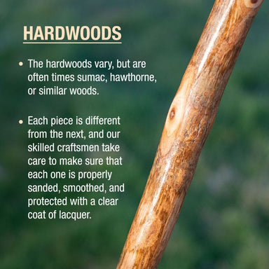 Close-up of a wooden stick with text about hardwoods on a blurred green background