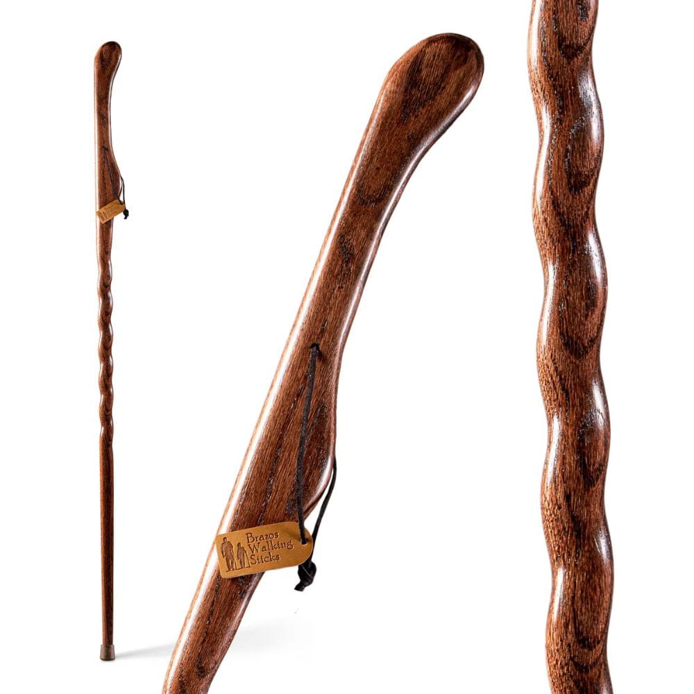 Wooden walking stick with a wavy handle on a white background