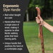 Wooden walking pole with hand holding it, set against a blurred natural background.