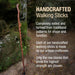 Handcrafted walking stick leaning against a stone wall with promotional text about traditional patterns and artisan craftsmanship.