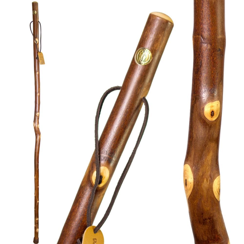 Three wooden walking sticks with decorative elements on a white background