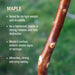 Wooden stick with text about maple wood's properties on a blurred green background