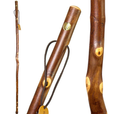 Three wooden walking sticks with decorative elements on a white background