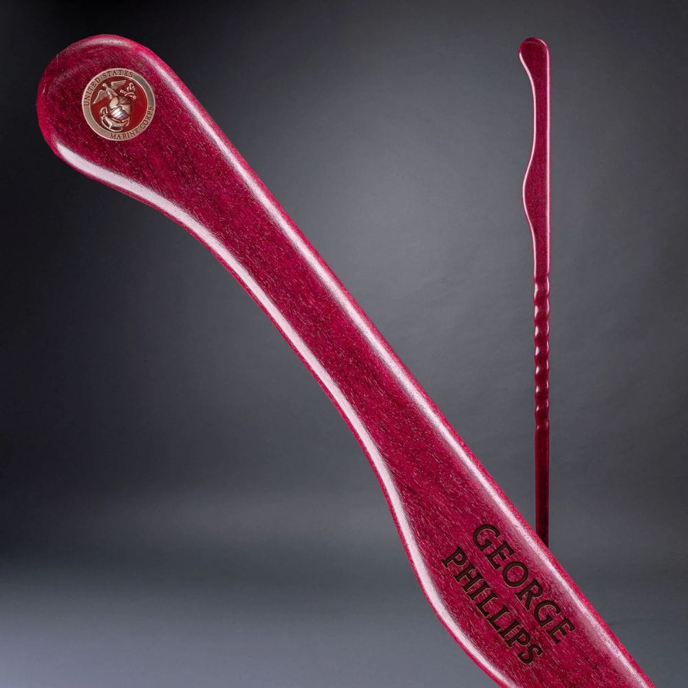 Red hair straightener with 'George Phillips' branding on a gray background