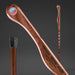 Wooden walking stick with engraved text on a dark gray background