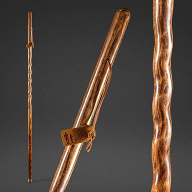 Wooden walking stick with a brand tag on a dark background