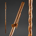 Wooden walking stick with a brand tag on a dark background