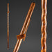 Wooden walking stick with a brand tag on a dark gray background