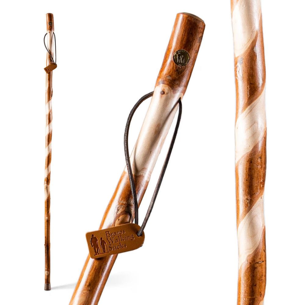 Wooden walking stick with leather patch on a white background