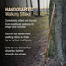 Handcrafted walking stick leaning against a tree with promotional text about its craftsmanship.