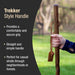 Wooden handle with a hand holding it, set against a blurred natural background.