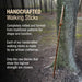 Handcrafted walking stick leaning against a tree in a forest setting with promotional text.