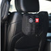Black tactical pouch with a first aid label attached to a car seat