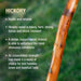 Hickory stick with text about its properties on a blurred green background