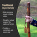 Hand holding a wooden hiking stick with text about traditional style handles.