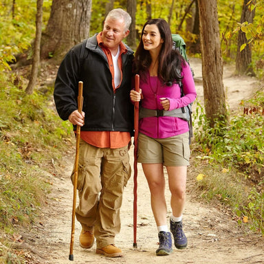 Man and woman hiking on a trail in a forest