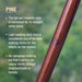 Wooden walking stick with text about pine wood and its uses