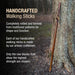 Handcrafted walking stick leaning against a tree with promotional text about traditional patterns and artisan craftsmanship.