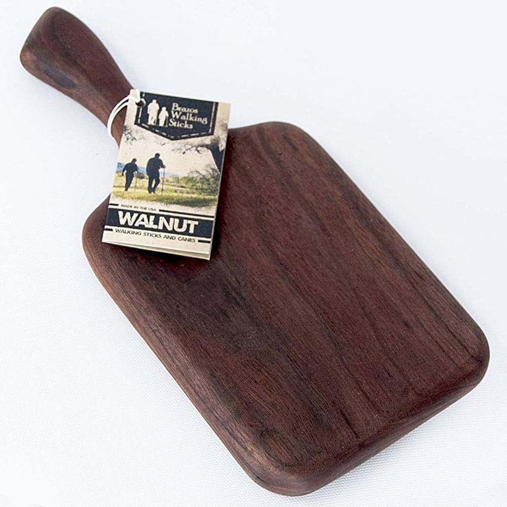 Wooden cutting board with a handle and a tag on a white background