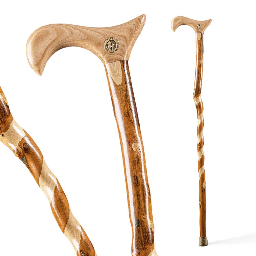 Three wooden walking sticks with decorative handles on a white background