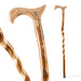 Three wooden walking sticks with decorative handles on a white background