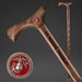 Wooden walking cane with engraved text and U.S. Marine Corps emblem on a dark background