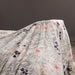 Floral patterned fabric draped over a surface with a dark background