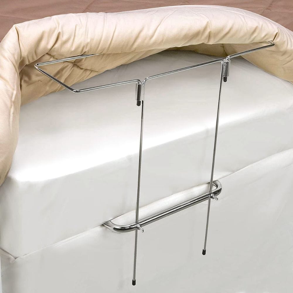 Metal bed rail attached to a white bed with beige bedding.