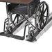 Wheelchair being used to ascend a set of stairs with a ramp attached.