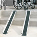 Two wheelchair ramps on a set of stairs with a wheelchair in the background.