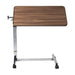 Wooden overbed table with adjustable height on a white background
