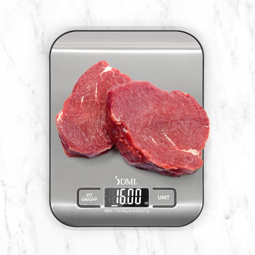 Two pieces of raw meat on a digital kitchen scale with a white marble background