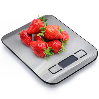 Digital kitchen scale with strawberries on a white background