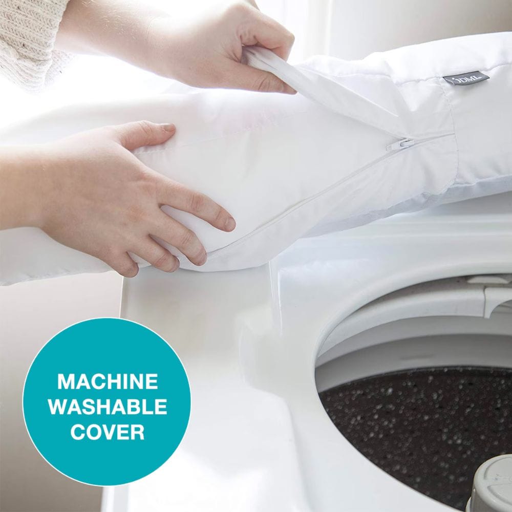 Person placing a machine washable cover on a washing machine, with a focus on the cover and washing machine.