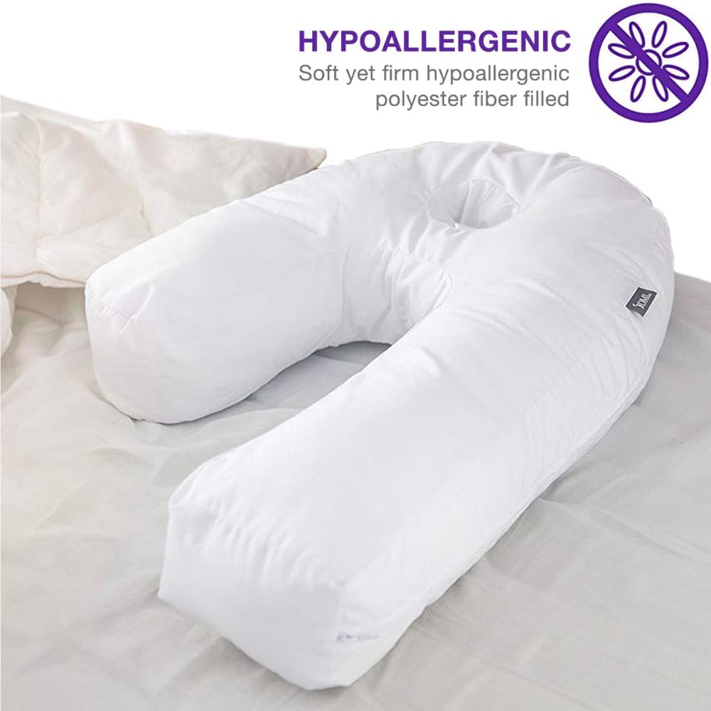 A white U-shaped maternity support pillow on a bed, with text overlay at the top reading 'HYPOALLERGENIC' and a purple insect icon, plus a small black fabric tag on the side.