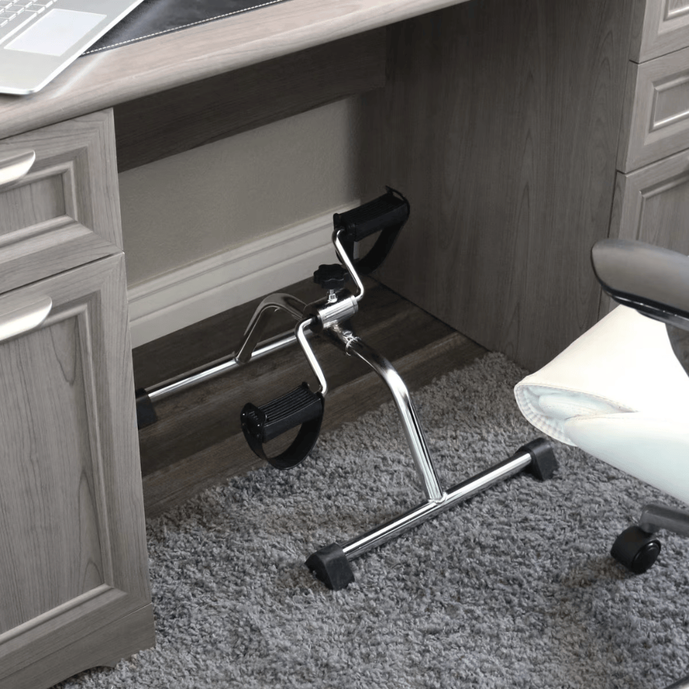 Small exercise bike under a desk in an office setting