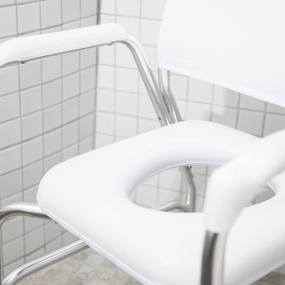 White chair with metal frame against a tiled wall
