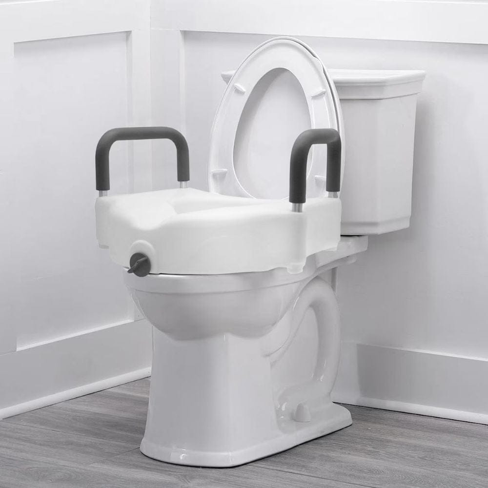 White toilet with a raised seat and handles in a bathroom setting