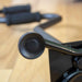Close-up of a black bicycle handlebar with blurred background