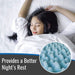 A woman lying in bed under white bedding, with a circular inset showing a close-up of a blue textured sleep cushion. Text at the bottom reads, 'Provides a Better Night’s Rest.
