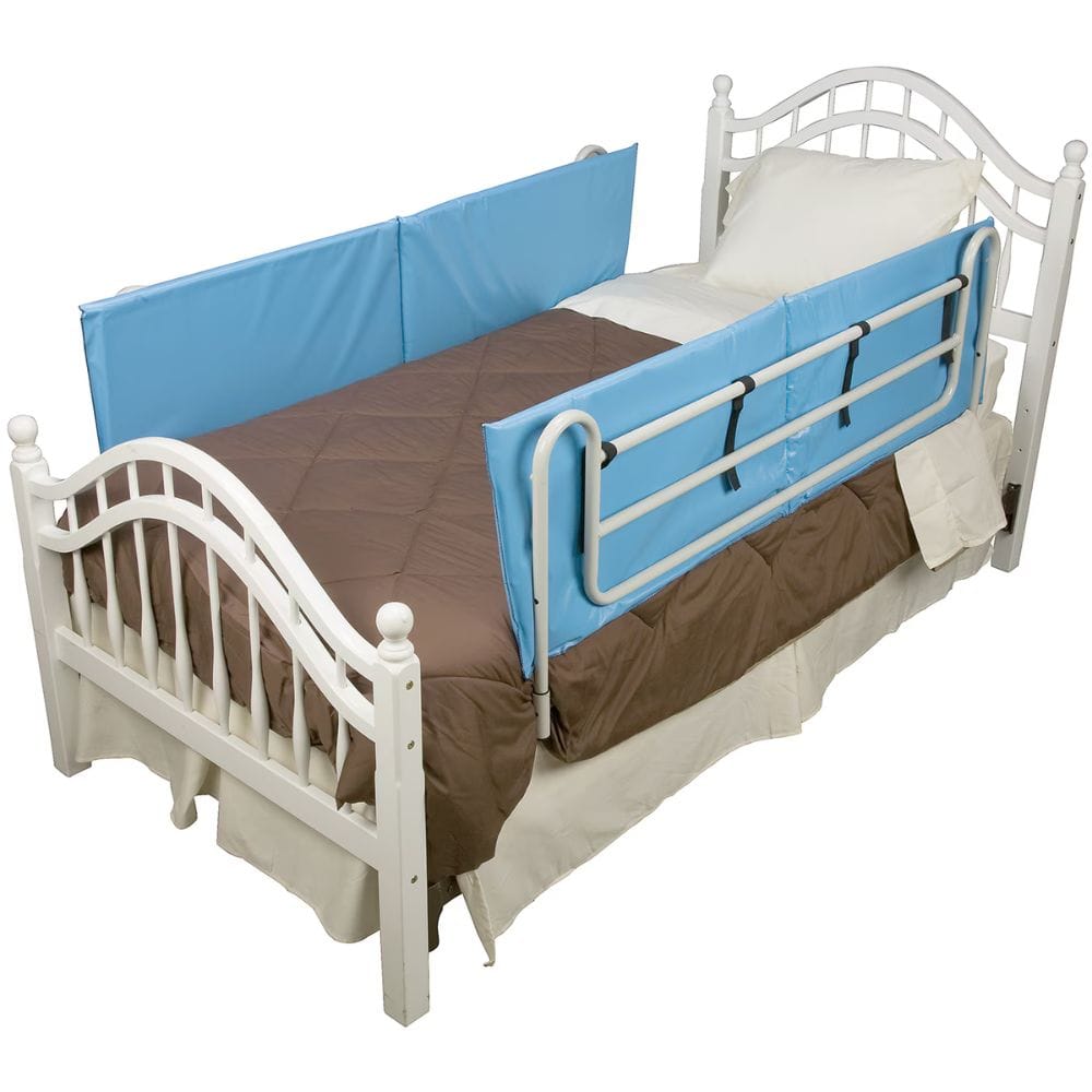 Bed with blue safety rail and brown bedding on a white background