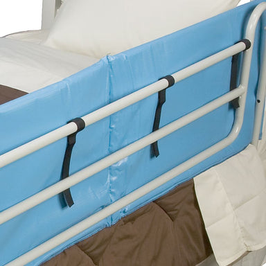 Bed rail with blue cover and white frame in a hospital setting