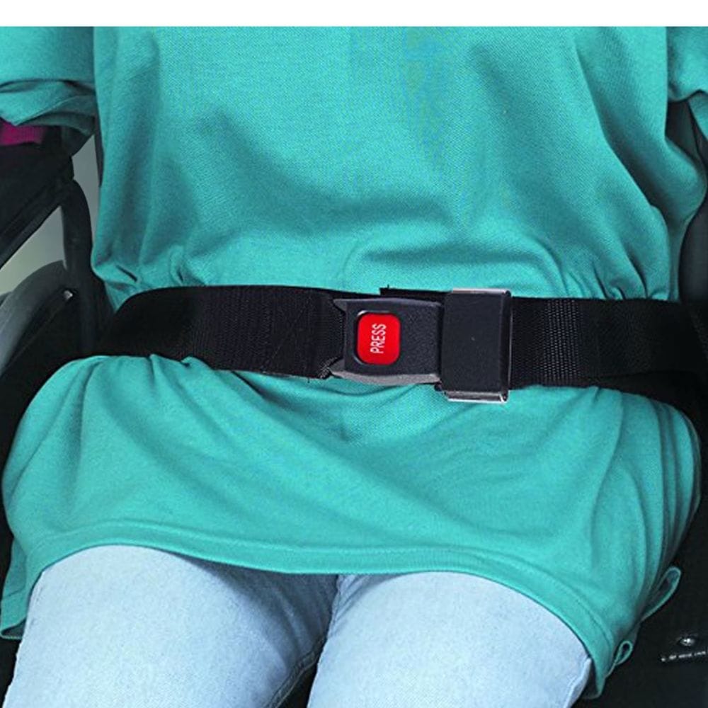 Person wearing a green shirt with a black belt and red buckle.