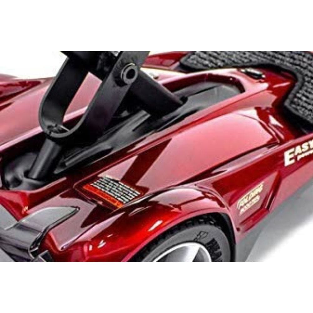 Close-up of a red toy car with a black steering wheel on a white background